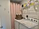 Functional laundry room featuring a washer, dryer, storage shelves, and woven laundry basket at 2921 Heavners Farm Ct, Lincolnton, NC 28092