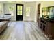 Bright living room featuring updated gray flooring, a black front door, and ample natural light at 2921 Heavners Farm Ct, Lincolnton, NC 28092