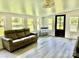 Bright, airy living room featuring neutral paint, laminate floors, and abundant natural light through many windows at 2921 Heavners Farm Ct, Lincolnton, NC 28092