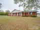 Charming single-story brick home featuring a classic covered front porch and lush front lawn at 3113 Old Pageland Marshville Rd, Wingate, NC 28174