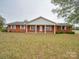 Attractive brick home with a covered porch, neat landscaping, and a welcoming front entrance at 3113 Old Pageland Marshville Rd, Wingate, NC 28174