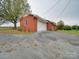 Exterior shot highlighting the brick home's attached garage with a large driveway at 3113 Old Pageland Marshville Rd, Wingate, NC 28174