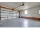 Large garage with concrete floor, white door, brick, and neutral wall color at 3113 Old Pageland Marshville Rd, Wingate, NC 28174