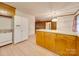 Kitchen with peninsula, refrigerator, dishwasher, and laminate countertops at 3113 Old Pageland Marshville Rd, Wingate, NC 28174
