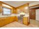 Kitchen area featuring wood cabinets, laminate countertops, and stainless steel range at 3113 Old Pageland Marshville Rd, Wingate, NC 28174