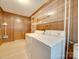 Well-organized laundry room with wood paneling, shelving, and a broom at 3113 Old Pageland Marshville Rd, Wingate, NC 28174