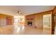 Inviting living room features a brick fireplace and wood paneling, offering a cozy space near the kitchen at 3113 Old Pageland Marshville Rd, Wingate, NC 28174