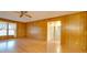 Bright and airy living room with wood paneling, featuring a large window and access to other areas at 3113 Old Pageland Marshville Rd, Wingate, NC 28174