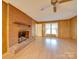 Inviting living room features a brick fireplace and wood paneling, creating a warm and cozy atmosphere at 3113 Old Pageland Marshville Rd, Wingate, NC 28174
