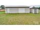 Outbuilding featuring a garage door and additional storage shed, set in a green field at 3113 Old Pageland Marshville Rd, Wingate, NC 28174