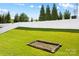 Expansive backyard featuring a pristine lawn and framed by a white fence, with mature trees at 3835 Norman View Dr, Sherrills Ford, NC 28673