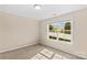 Bedroom with bright sunlight streaming through a large window with light carpeting at 3835 Norman View Dr, Sherrills Ford, NC 28673