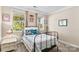 Sunlit bedroom featuring a black metal frame bed, two windows, and a cozy atmosphere at 3835 Norman View Dr, Sherrills Ford, NC 28673
