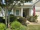 Inviting front porch with decorative plants and an American flag at 3835 Norman View Dr, Sherrills Ford, NC 28673