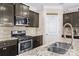 Close-up of the kitchen area showcasing the stainless steel appliances, granite countertops, and neutral backsplash at 3835 Norman View Dr, Sherrills Ford, NC 28673