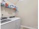 Bright laundry room featuring a washer and dryer with storage shelving at 3835 Norman View Dr, Sherrills Ford, NC 28673