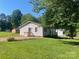 Lush backyard with a small wooden deck, green grass, and plenty of space for outdoor activities at 3973 English Oak Dr, Lincolnton, NC 28092