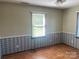 Cozy bedroom with hardwood floors, a window with blinds, and decorative wallpaper at 3973 English Oak Dr, Lincolnton, NC 28092