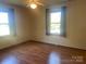 Bedroom featuring hardwood floors, a ceiling fan, and natural light from two windows at 3973 English Oak Dr, Lincolnton, NC 28092
