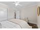 Cozy bedroom with white walls, plush bedding, ceiling fan, and charming decor for a restful retreat at 404 Wakefield Dr # C, Charlotte, NC 28209