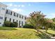 Well-kept apartment building featuring neatly manicured lawns, mature trees, and charming architectural details at 404 Wakefield Dr # C, Charlotte, NC 28209