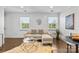 Bright living room boasts a stylish sofa, unique coffee table, and hardwood floors at 404 Wakefield Dr # C, Charlotte, NC 28209