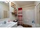 Bathroom featuring a white vanity, framed art, decorative shower curtain and linen-look wall hanging at 407 Hertling Nw Dr, Concord, NC 28027