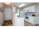 Practical kitchen with white appliances, counter space, and easy access to the main entrance at 407 Hertling Nw Dr, Concord, NC 28027