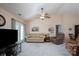Inviting living room featuring neutral colors, plush carpeting and a ceiling fan for optimal comfort at 407 Hertling Nw Dr, Concord, NC 28027