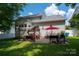 Spacious backyard featuring an outdoor dining area and lounge with a pergola at 512 Veloce Trl, Fort Mill, SC 29715
