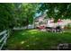 Well-manicured lawn featuring a patio, outdoor seating, and mature shade trees at 512 Veloce Trl, Fort Mill, SC 29715