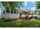 Well-maintained backyard with a patio, pergola, grill, seating area, and lush green lawn at 512 Veloce Trl, Fort Mill, SC 29715