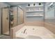 Bright bathroom featuring a soaking tub, glass enclosed shower, and decorative shelving at 512 Veloce Trl, Fort Mill, SC 29715