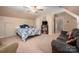 Cozy bedroom featuring neutral carpets, a sofa, and private ensuite access at 512 Veloce Trl, Fort Mill, SC 29715