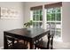 Bright breakfast nook features a dark wood table, matching chairs, and natural light from two windows at 512 Veloce Trl, Fort Mill, SC 29715