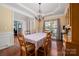 Spacious dining room featuring tray ceilings and views into the office and kitchen at 512 Veloce Trl, Fort Mill, SC 29715