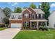 Charming two-story brick home with a well-manicured lawn and inviting front porch at 512 Veloce Trl, Fort Mill, SC 29715