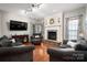 Well-lit living room with hardwood floors, stone fireplace, and comfortable seating arrangements at 512 Veloce Trl, Fort Mill, SC 29715