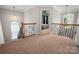 Bright, carpeted loft space with an iron railing and views of the home's interior at 512 Veloce Trl, Fort Mill, SC 29715