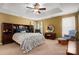 Spacious main bedroom with tray ceiling, carpet, and dark wood furniture at 512 Veloce Trl, Fort Mill, SC 29715