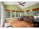 Bright sunroom with vaulted ceiling, hardwood floors, large windows, comfortable seating, and decorative plants at 512 Veloce Trl, Fort Mill, SC 29715