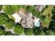 An aerial view shows a gorgeous home with a pool, and a beautiful, lush green landscape surrounding it at 600 Beauhaven Ln, Waxhaw, NC 28173