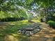 Landscaped backyard with rock garden, steps, and pergola enhances the property's natural beauty at 600 Beauhaven Ln, Waxhaw, NC 28173