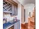 Convenient bar area featuring a granite countertop, custom cabinets, wine fridge, and tile backsplash at 600 Beauhaven Ln, Waxhaw, NC 28173
