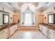 Luxury bathroom with a soaking tub, dual sinks, and decorative lighting at 600 Beauhaven Ln, Waxhaw, NC 28173