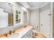 Bathroom with dual sinks, granite countertops, and a large window, offering plenty of space and natural light at 600 Beauhaven Ln, Waxhaw, NC 28173