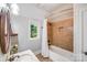 Cozy bathroom featuring a shower-tub combination, window, and neutral tiling at 600 Beauhaven Ln, Waxhaw, NC 28173