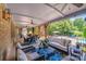 Inviting covered patio area features ample seating, ceiling fans, and opens up to a beautiful pool and backyard at 600 Beauhaven Ln, Waxhaw, NC 28173
