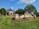 Elegant community entrance with stone signage, manicured landscaping, and a welcoming gatehouse at 600 Beauhaven Ln, Waxhaw, NC 28173