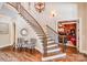 The foyer showcases a curved staircase with wood treads and wrought iron railings, complemented by stylish decor at 600 Beauhaven Ln, Waxhaw, NC 28173